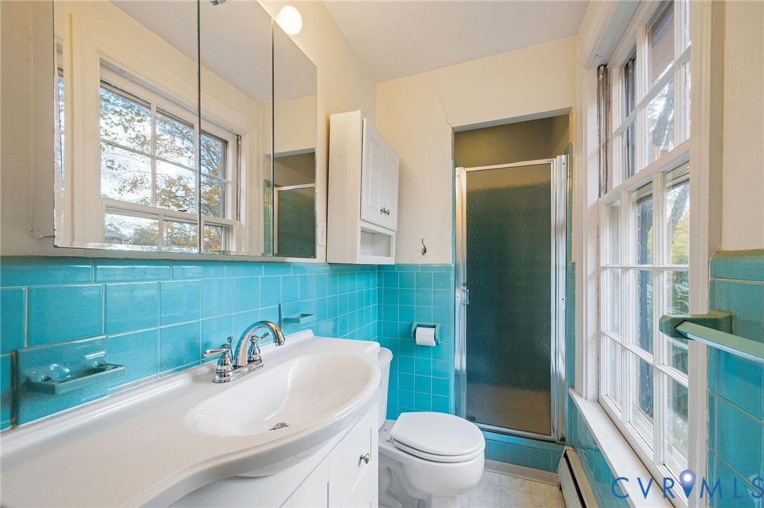 2831 Braidwood Road Richmond, VA 23225 - Photo 30 of 50 a bathroom with a sink a toilet and shower