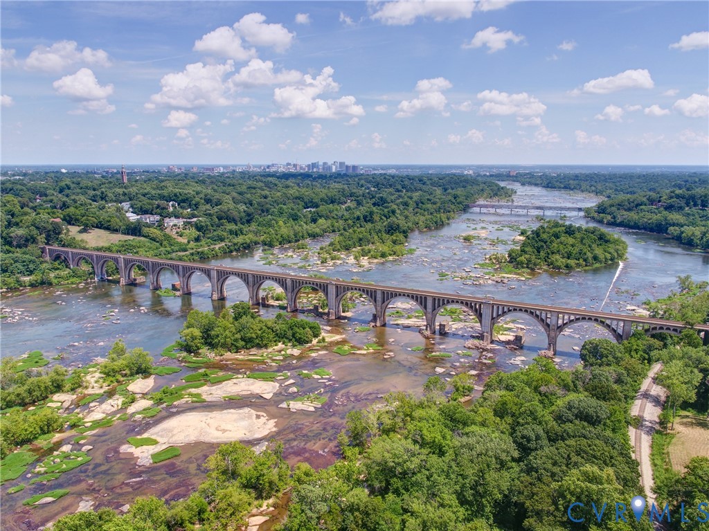 2831 Braidwood Road Richmond, VA 23225 - Photo 42 of 50 a view of a lake with a garden in front of it