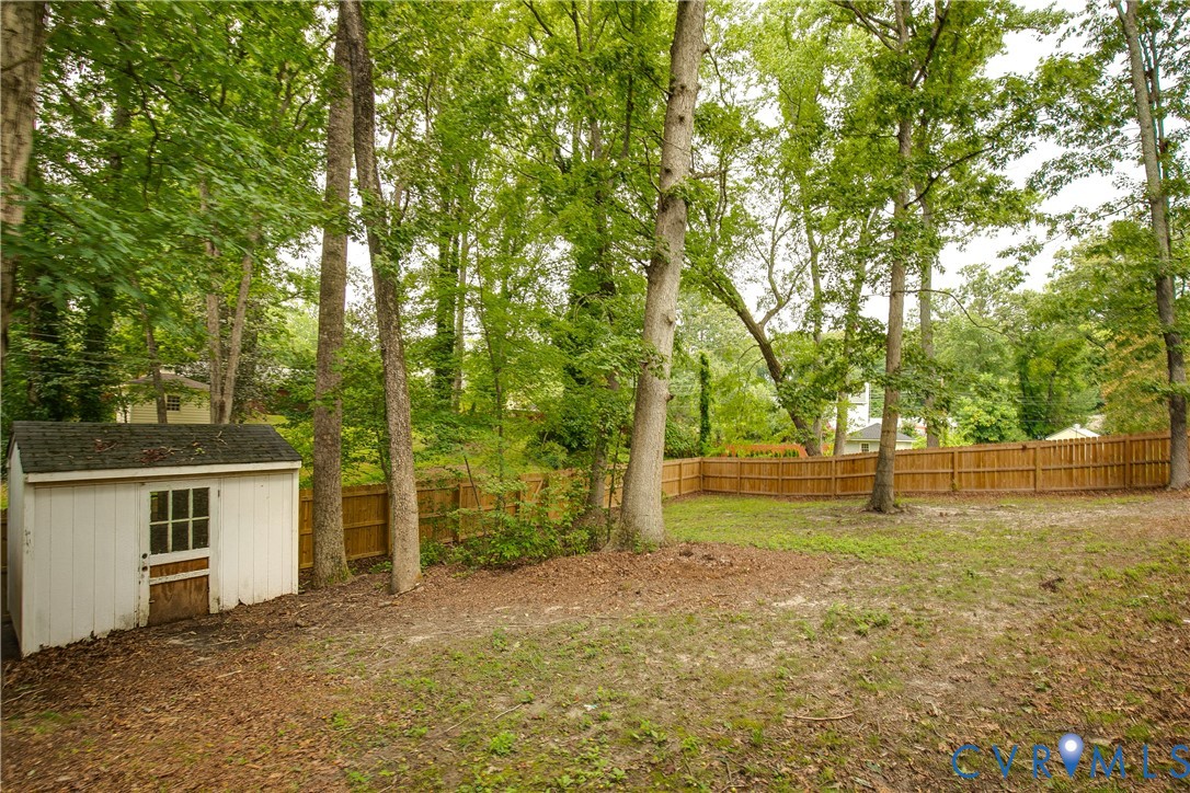 200 Stanmore Road North Chesterfield, VA 23236 - Photo 37 of 37 Fenced backyard with mature trees and a white stor