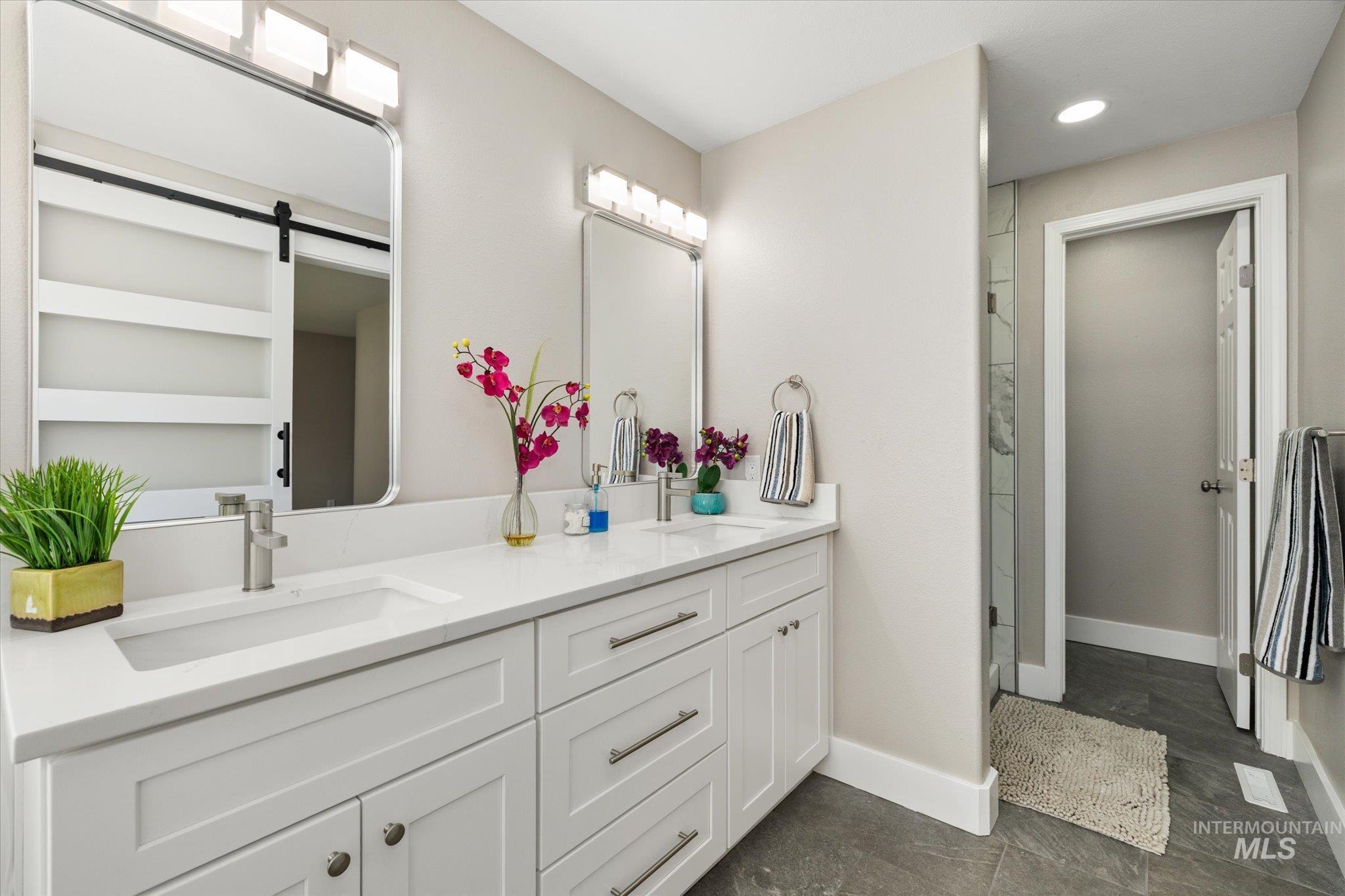 2250 North Amethyst Avenue Meridian, ID 83646 - Photo 33 of 50 Full bathroom featuring double vanity, a shower stall, and recessed lighting