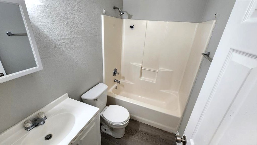 605 Martin Luther King Boulevard, Unit A Elgin, TX 78621 - Photo 13 of 18 a bathroom with a sink toilet and shower