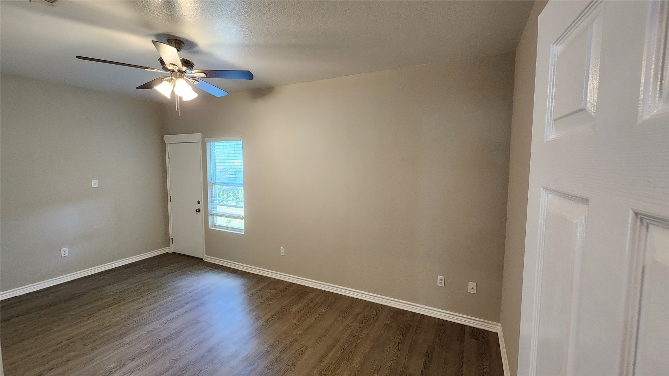 605 Martin Luther King Boulevard, Unit A Elgin, TX 78621 - Photo 14 of 18 wooden floor in an empty room with a window
