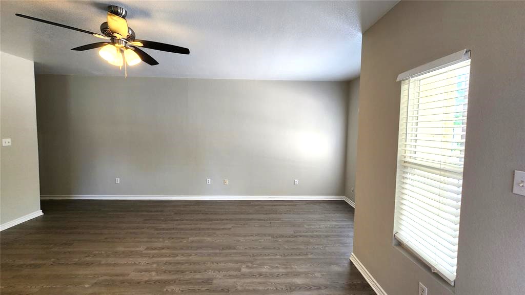 605 Martin Luther King Boulevard, Unit A Elgin, TX 78621 - Photo 17 of 18 a view of an empty room with window and wooden floor