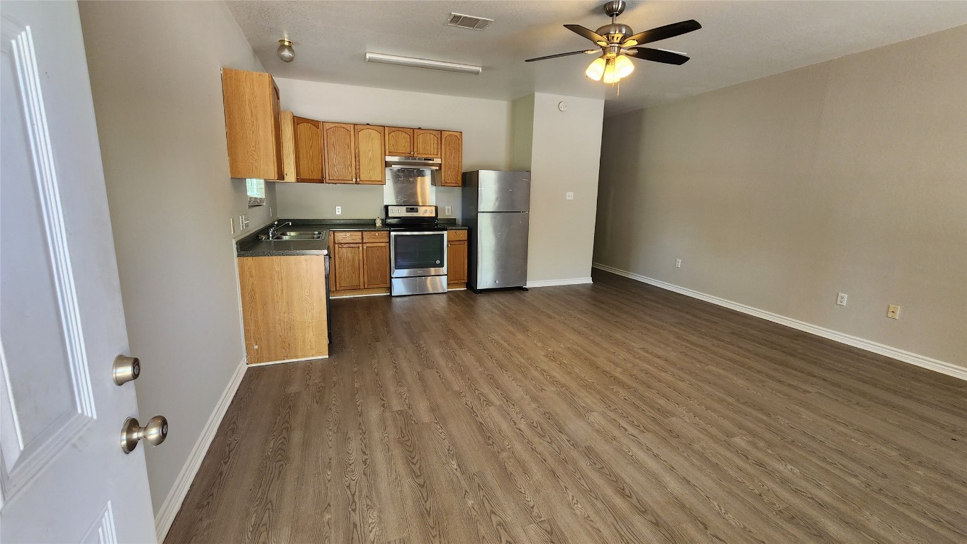 605 Martin Luther King Boulevard, Unit A Elgin, TX 78621 - Photo 2 of 18 a kitchen with stainless steel appliances a refrigerator and a stove top oven