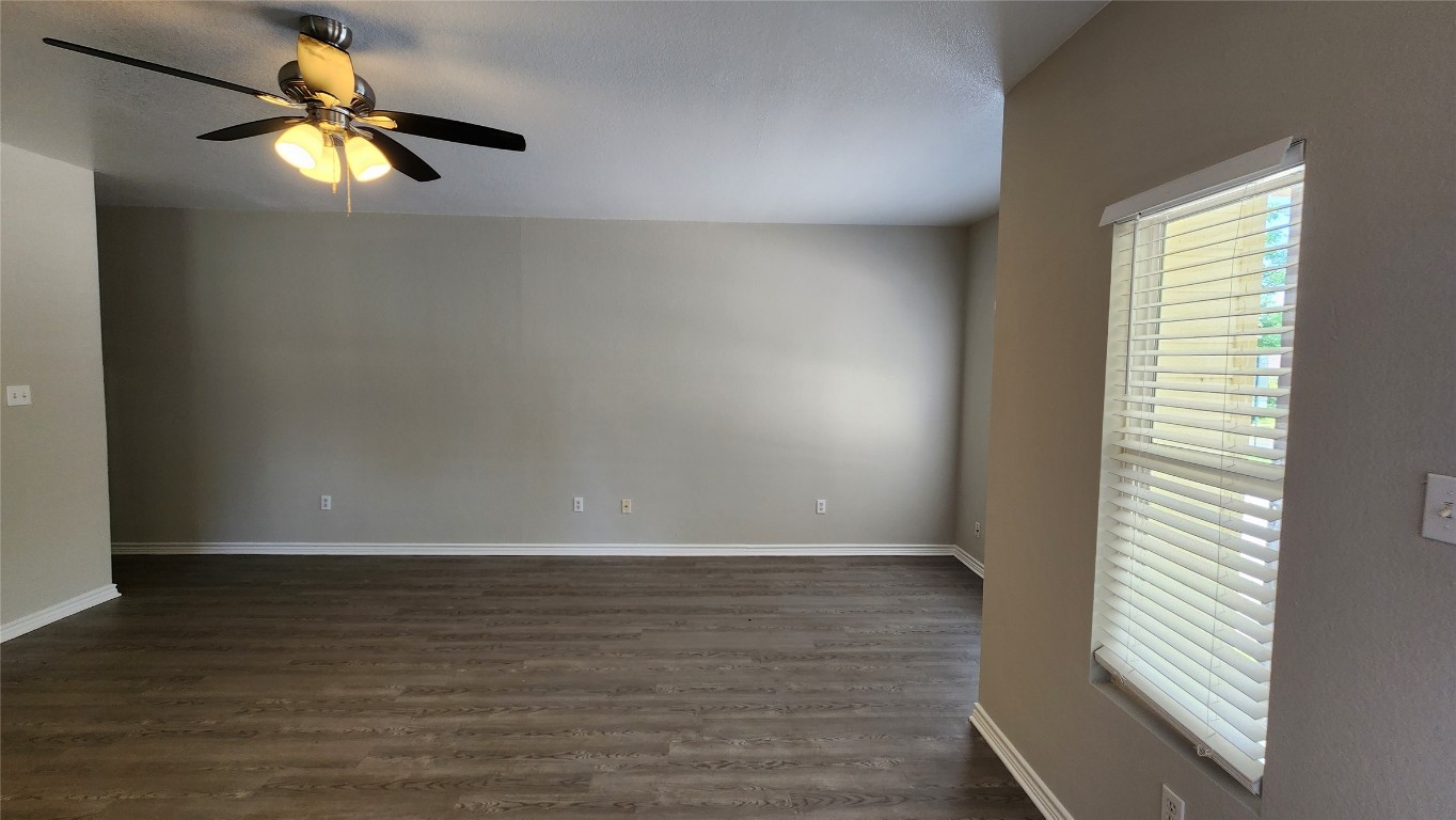 605 Martin Luther King Boulevard, Unit A Elgin, TX 78621 - Photo 3 of 18 a view of an empty room with window and wooden floor