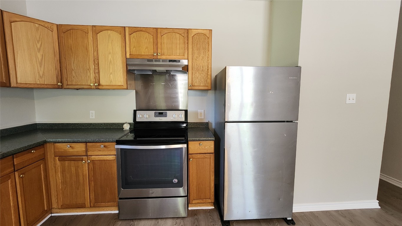 605 Martin Luther King Boulevard, Unit A Elgin, TX 78621 - Photo 6 of 18 a kitchen with a refrigerator and a stove
