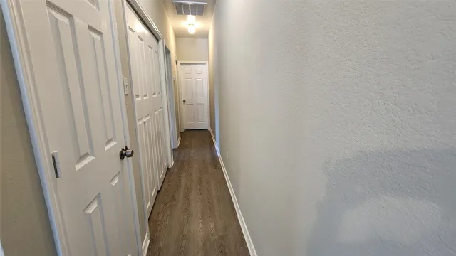 a view of a hallway with a wooden door