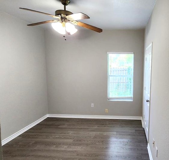 605 Martin Luther King Boulevard, Unit A Elgin, TX 78621 - Photo 10 of 18 wooden floor in an empty room with a window