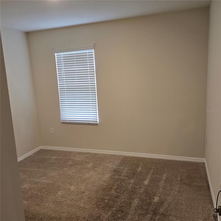 814 Sun Burst Road Winter Haven, FL 33880 - Photo 15 of 48 an empty room with a window