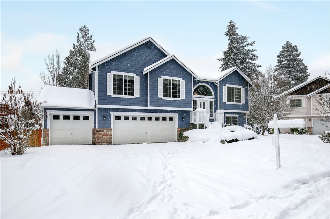 4705 152nd Place Southeast Bothell, WA 98012 - Photo 1 of 1 a view of a house with a yard covered in snow