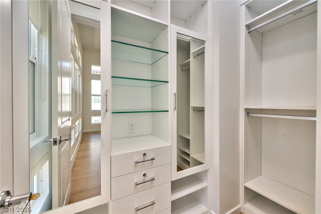 3327 Esker Rdg Avenue Henderson, NV 89044 - Photo 11 of 24 Custom shelving and hanging rods offer versatile storage in this well-appointed closet space.