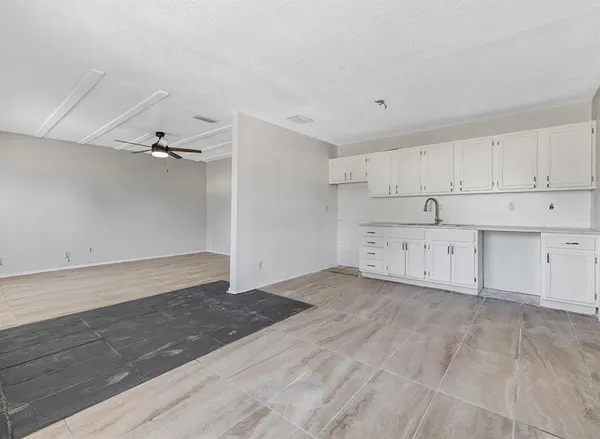 a view of a kitchen with a sink dishwasher and a refrigerator