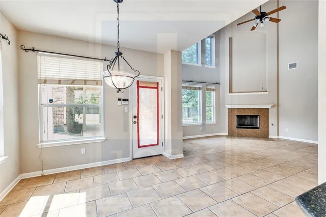 a view interior of a house with wooden floor fireplace and windows