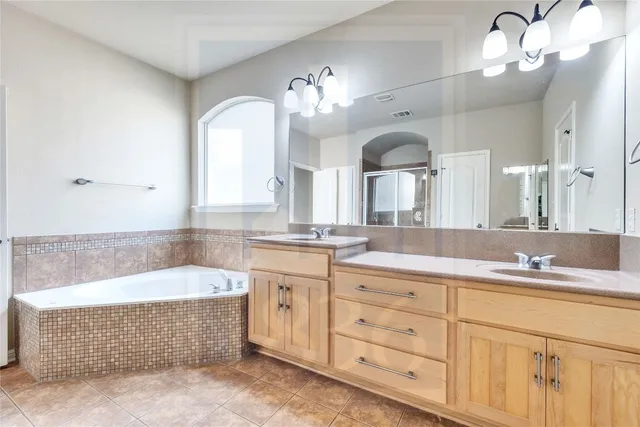 a bathroom with a shower and a glass door