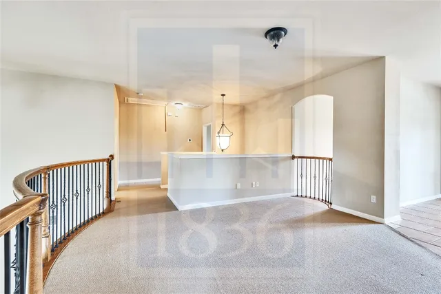 an empty room with wooden floor and a bathroom