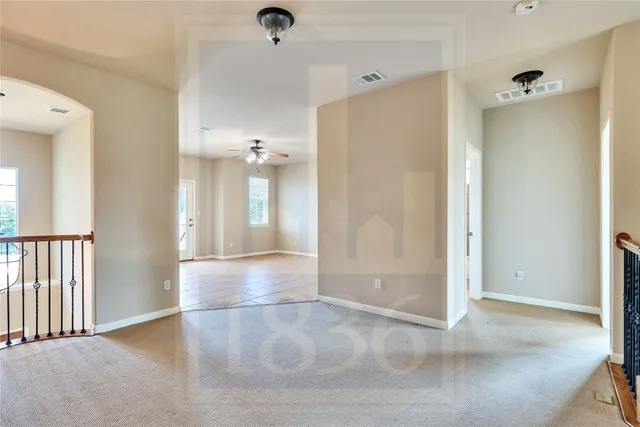 a view of a livingroom with a ceiling fan and window