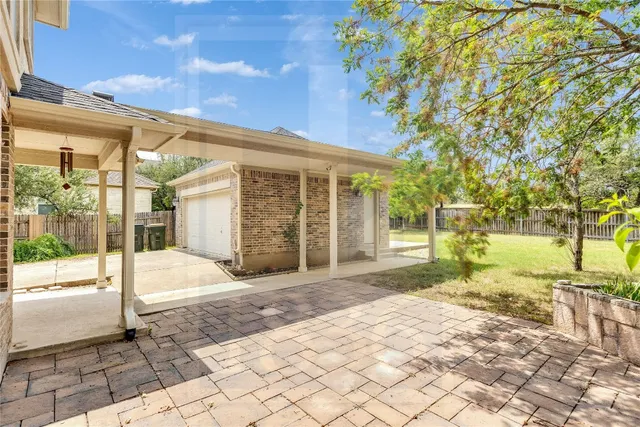 a view of a brick house with large windows