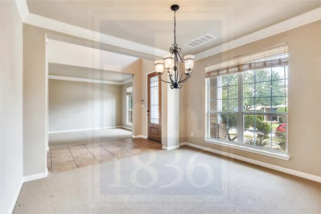 a view of a room with a windows and ceiling fan