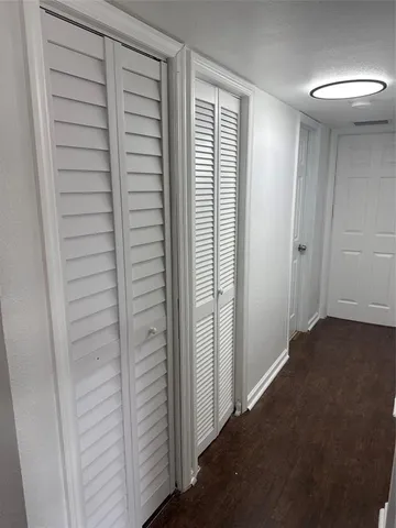 an entryway door with wooden floor