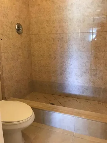 an empty room with wooden floor and cabinet