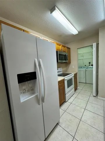 a kitchen with a stove top oven and cabinets