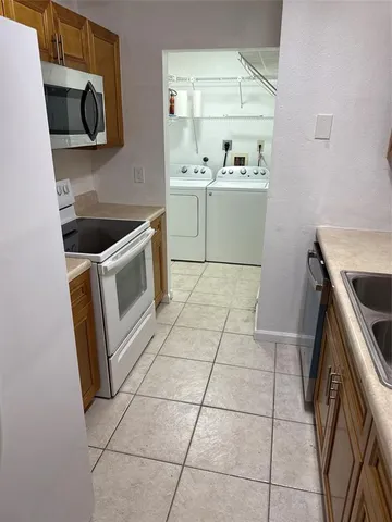 a kitchen with a stove microwave and sink
