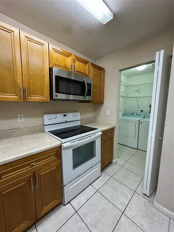 a kitchen with a stove and a microwave