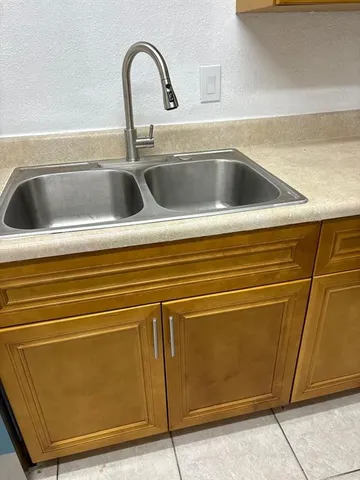 a kitchen with a sink and cabinets