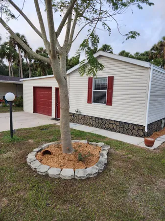 a view of a house with a backyard
