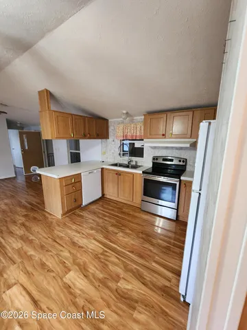a kitchen with stainless steel appliances a stove a refrigerator and a sink