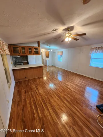 a view of a room with wooden floor