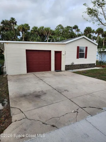 a view of a house with a yard and garage