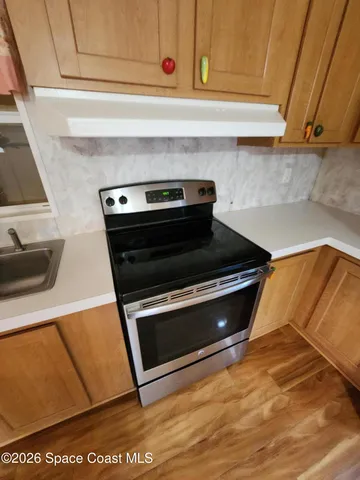 a stove top oven sitting inside of a kitchen