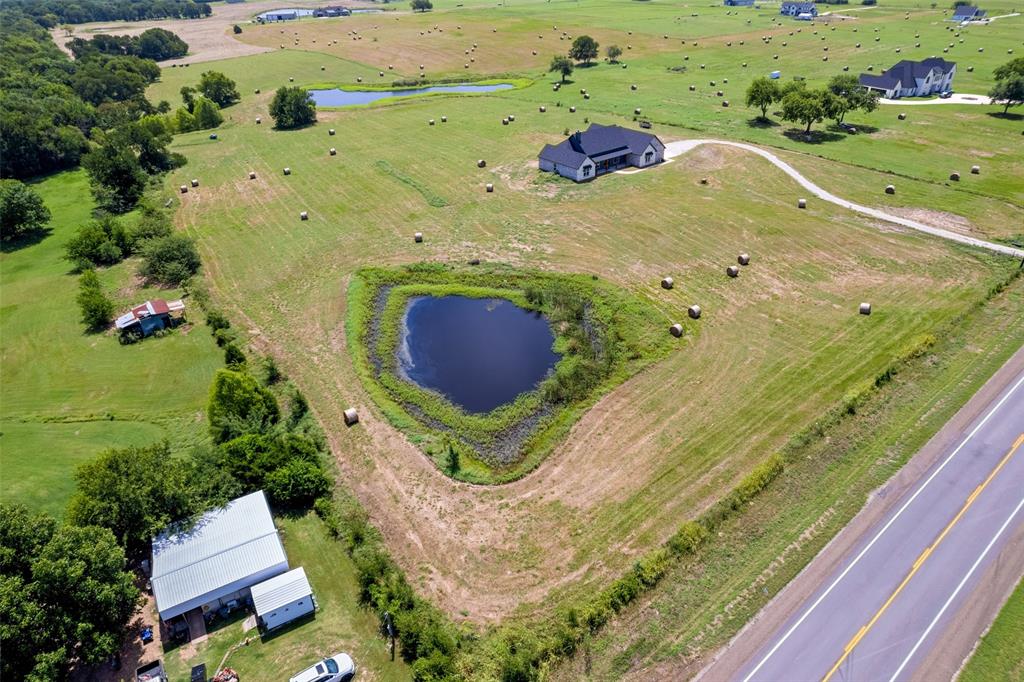 4411 Fm 751 Wills Point Wills Point, TX 75169 - Photo 38 of 40 Expansive rural property featuring a private pond, open fields, and a modern single-story residence