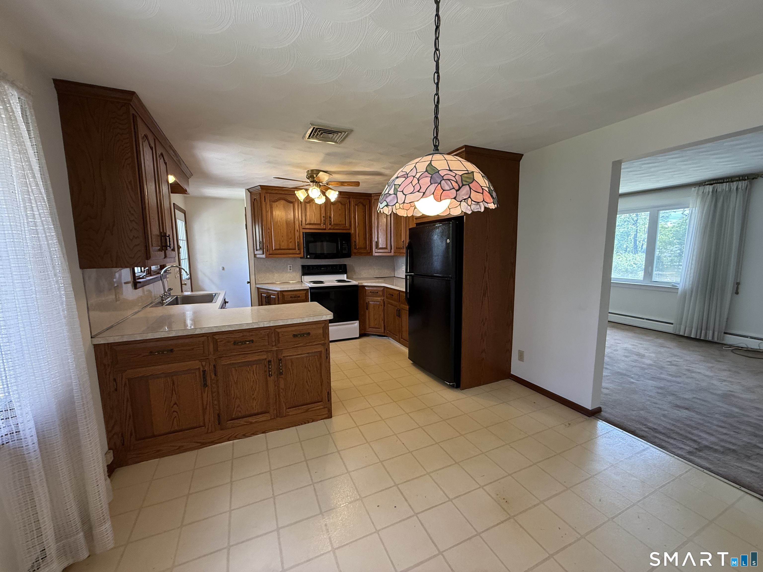 26 Maple Street Trumbull, CT 06611 - Photo 11 of 37 a kitchen with a sink a counter top space appliances and cabinets