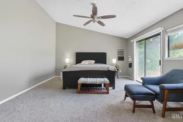 a bedroom with furniture and a large window