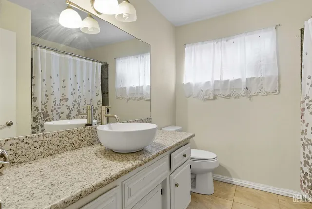 a bath room with a toilet sink and a shower