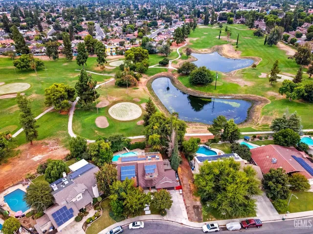 an aerial view of residential houses with outdoor space and swimming pool