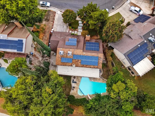 an aerial view of a house with garden space and street view