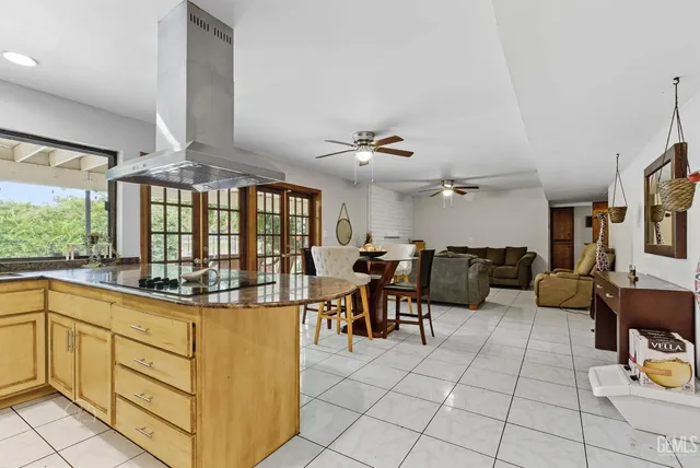a very nice looking living room with kitchen and furniture
