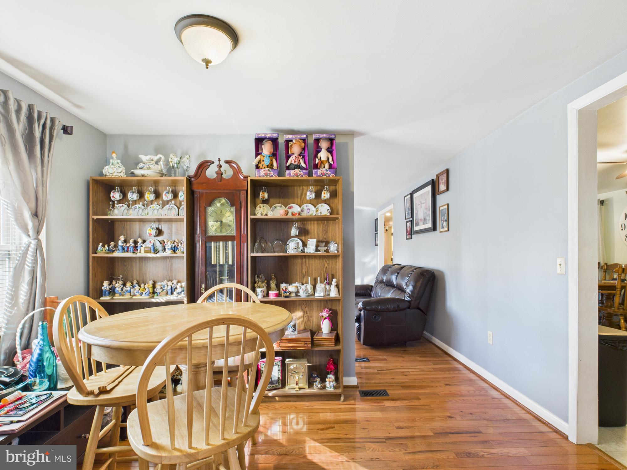 364 Bethel Grange Road Winchester, VA 22603 - Photo 24 of 52 a living room with furniture a dining table and a chandelier