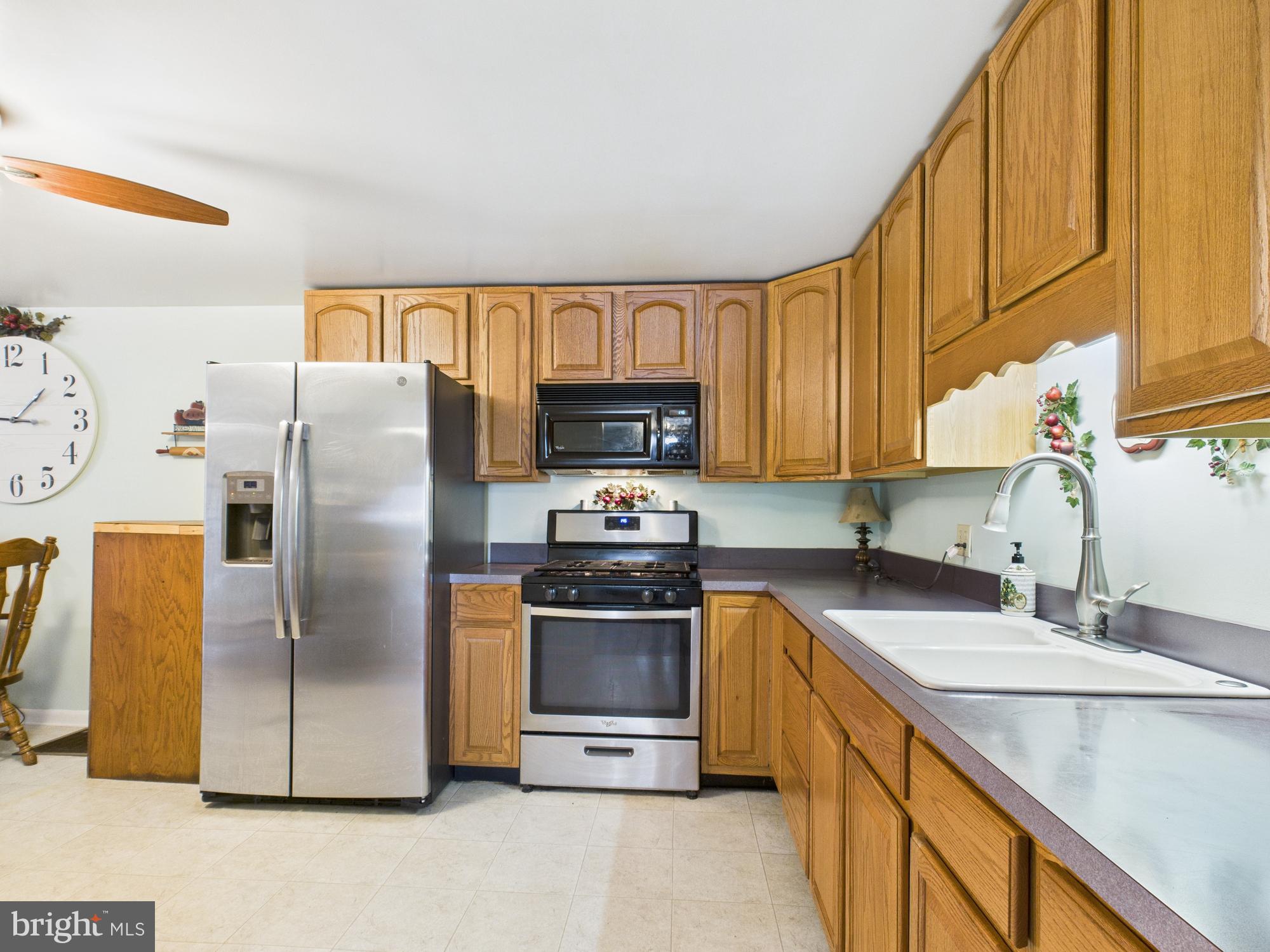 364 Bethel Grange Road Winchester, VA 22603 - Photo 31 of 52 a kitchen with stainless steel appliances granite countertop a sink a stove a refrigerator a microwave a sink and cabinets