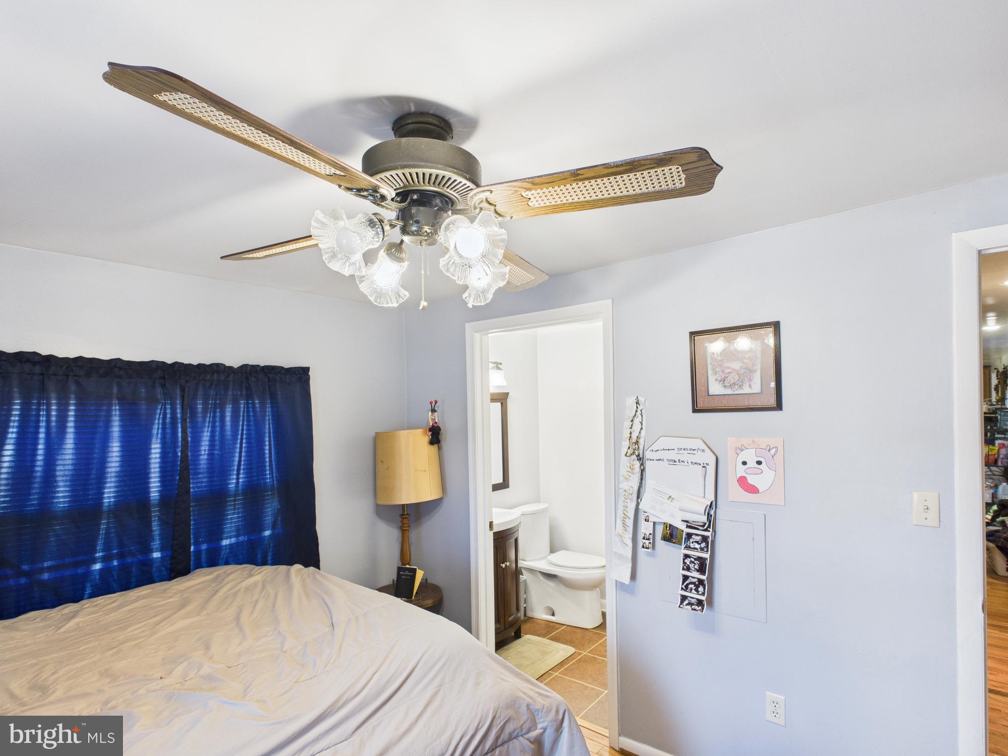 364 Bethel Grange Road Winchester, VA 22603 - Photo 45 of 52 a bedroom with a bed and a chandelier