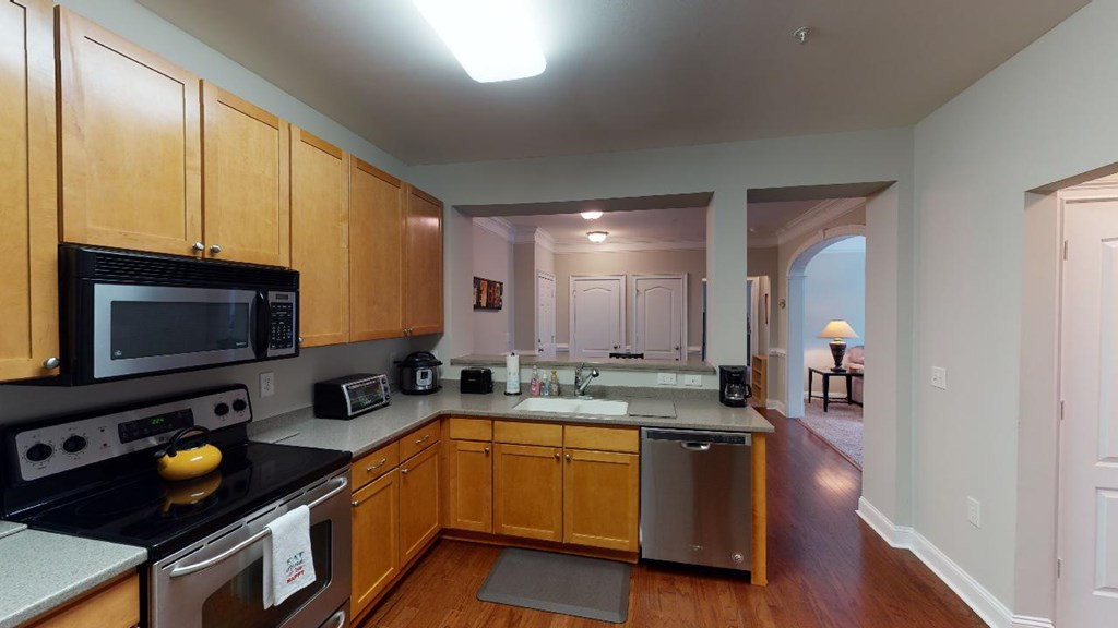 3811 Lunceston Way, Unit 105 Raleigh, NC 27613 - Photo 21 of 49 Kitchen with Pass-thru to Dining Area