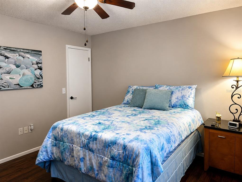 11177 Elgin Boulevard Spring Hill, FL 34608 - Photo 7 of 10 a bedroom with a bed and wooden floor