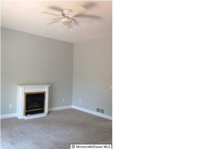 121 Castaway Road Manahawkin, NJ 08050 - Photo 2 of 3 a view of empty room with a fireplace