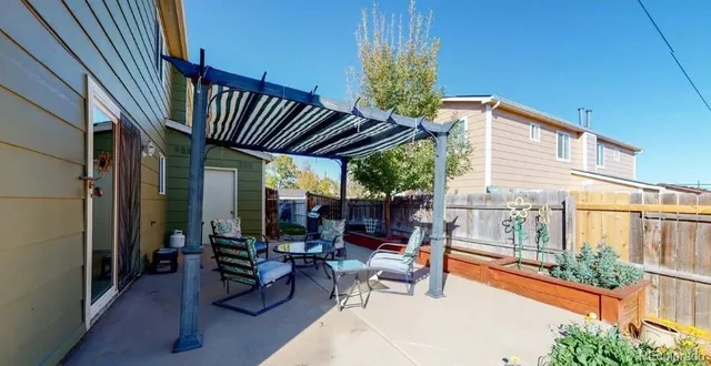 a building outdoor space with patio furniture and potted plants