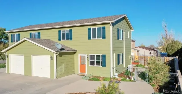 a view of a house with a yard and plants