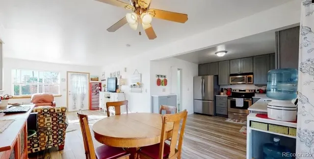a dining room with furniture and wooden floor