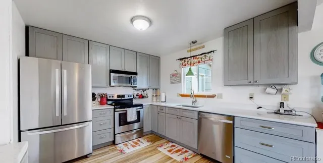 a kitchen with stainless steel appliances a refrigerator sink and cabinets
